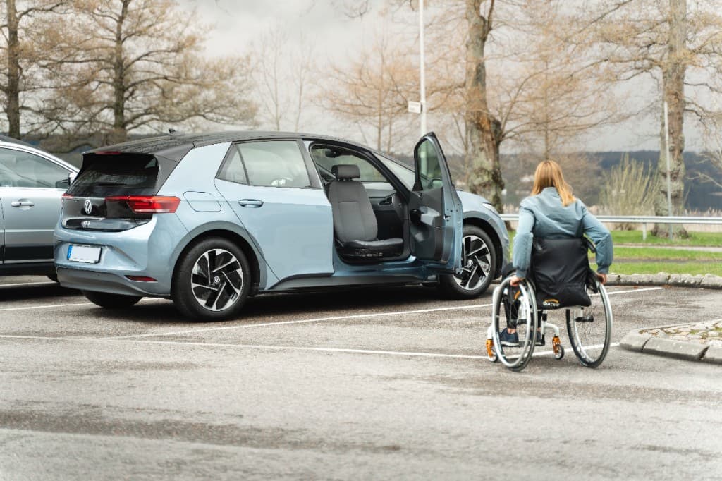Vehicle access adaptation with wheelchair transfer